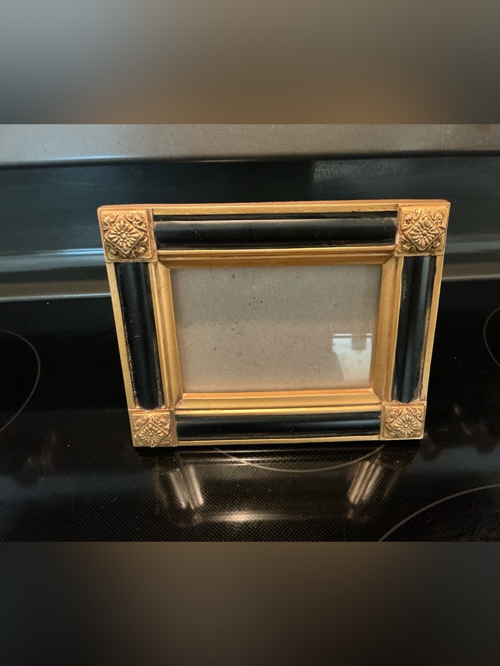 black and gold photo frame, ornate, gilded Victorian-inspired corner medallions